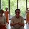 Group of adults engaging in light exercise, smiling.