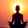 Person meditating at sunrise, calm and serene.